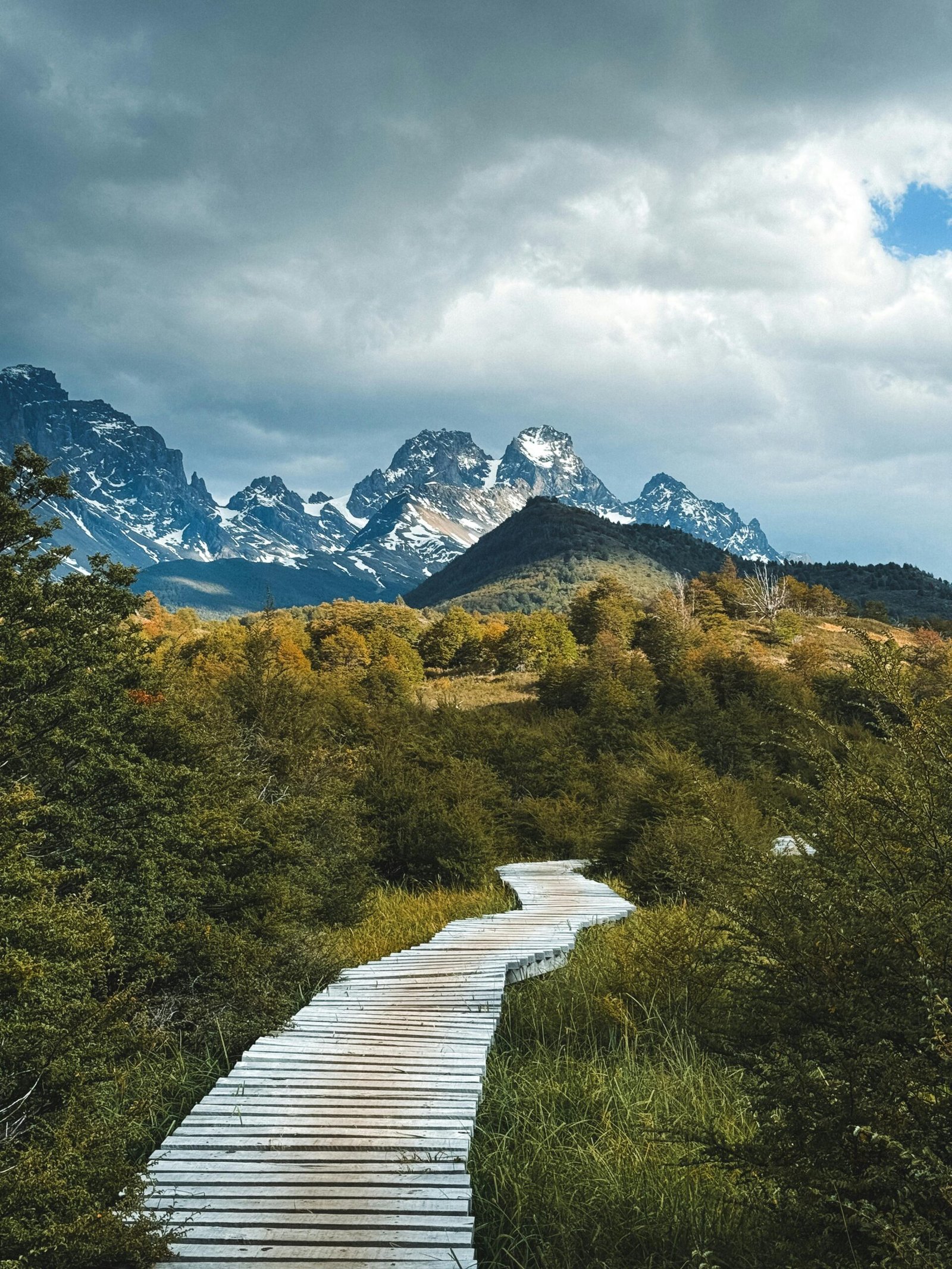 Serene boardwalk leading to the majestic mountains in Torres del Paine National Park, Chile.